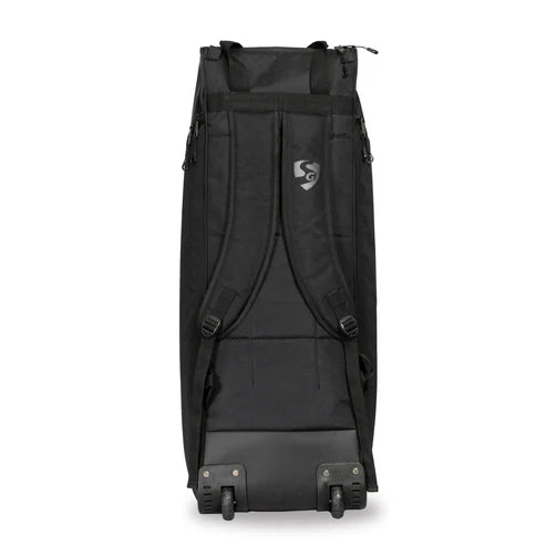Back view of SG KLR cricket wheelie kit bag showing padded backpack shoulder straps with chest buckle, SG logo, and two large wheels with HDPE base for ground stability