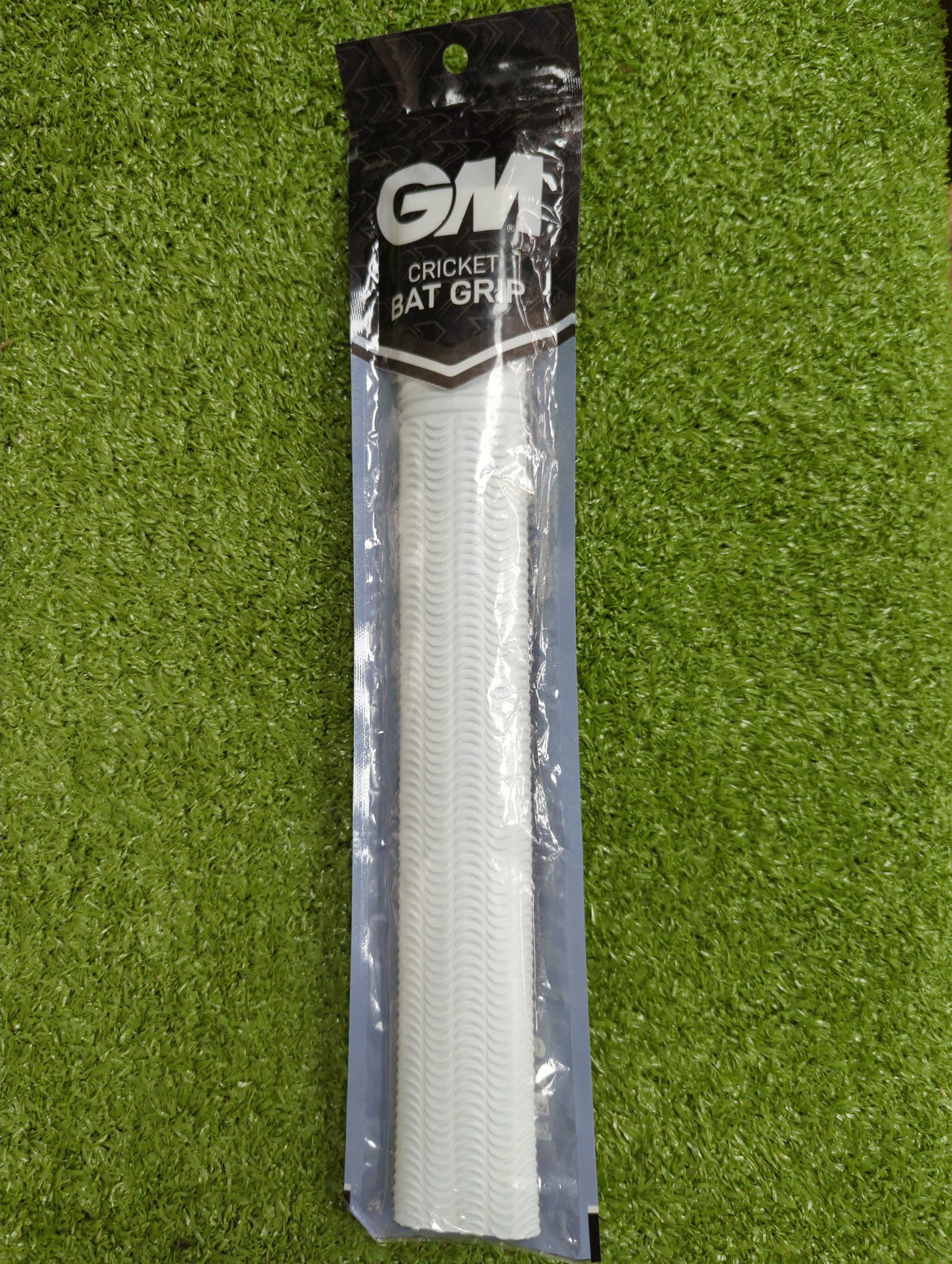 Full front view of the packaged GM Ripple Cricket Bat Grip in white, showing its full length and unique ripple texture.