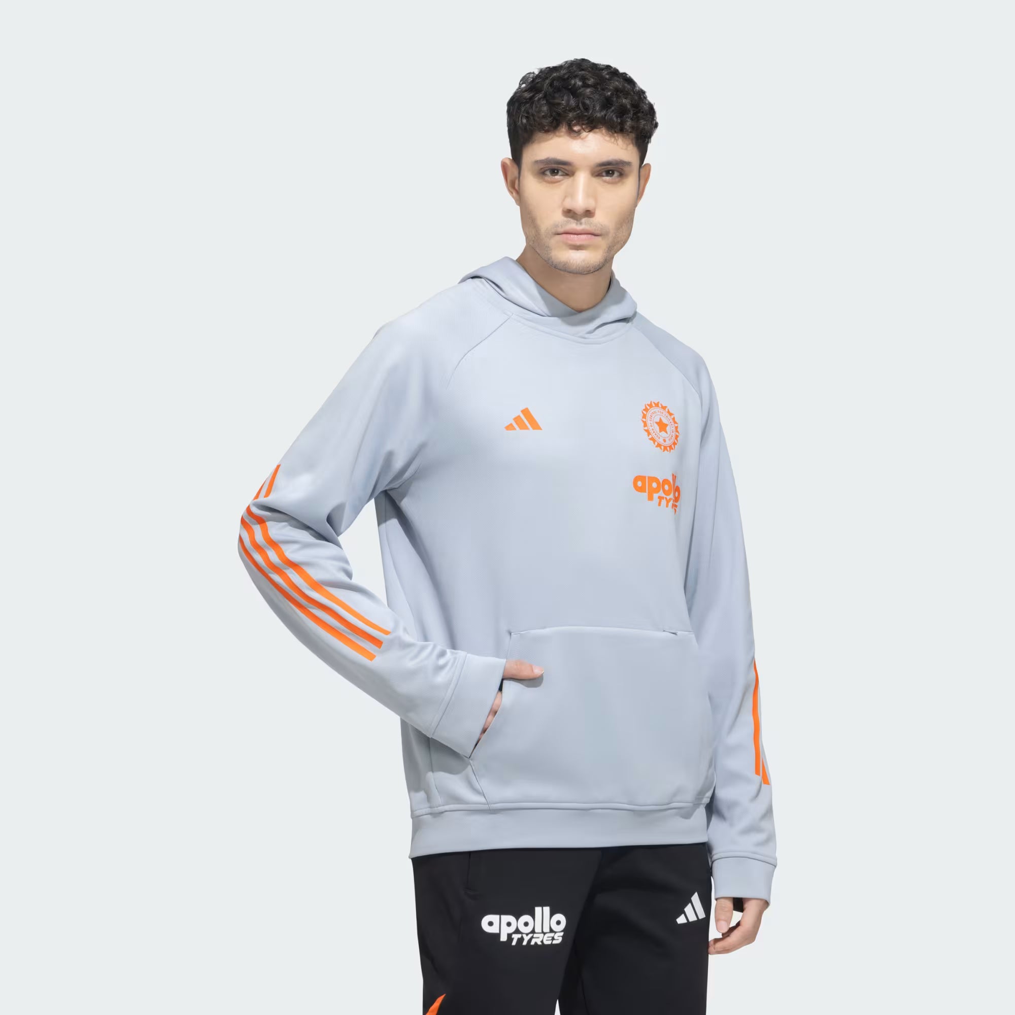 India Cricket Hoodie Halo Silver featuring classic orange Adidas stripes