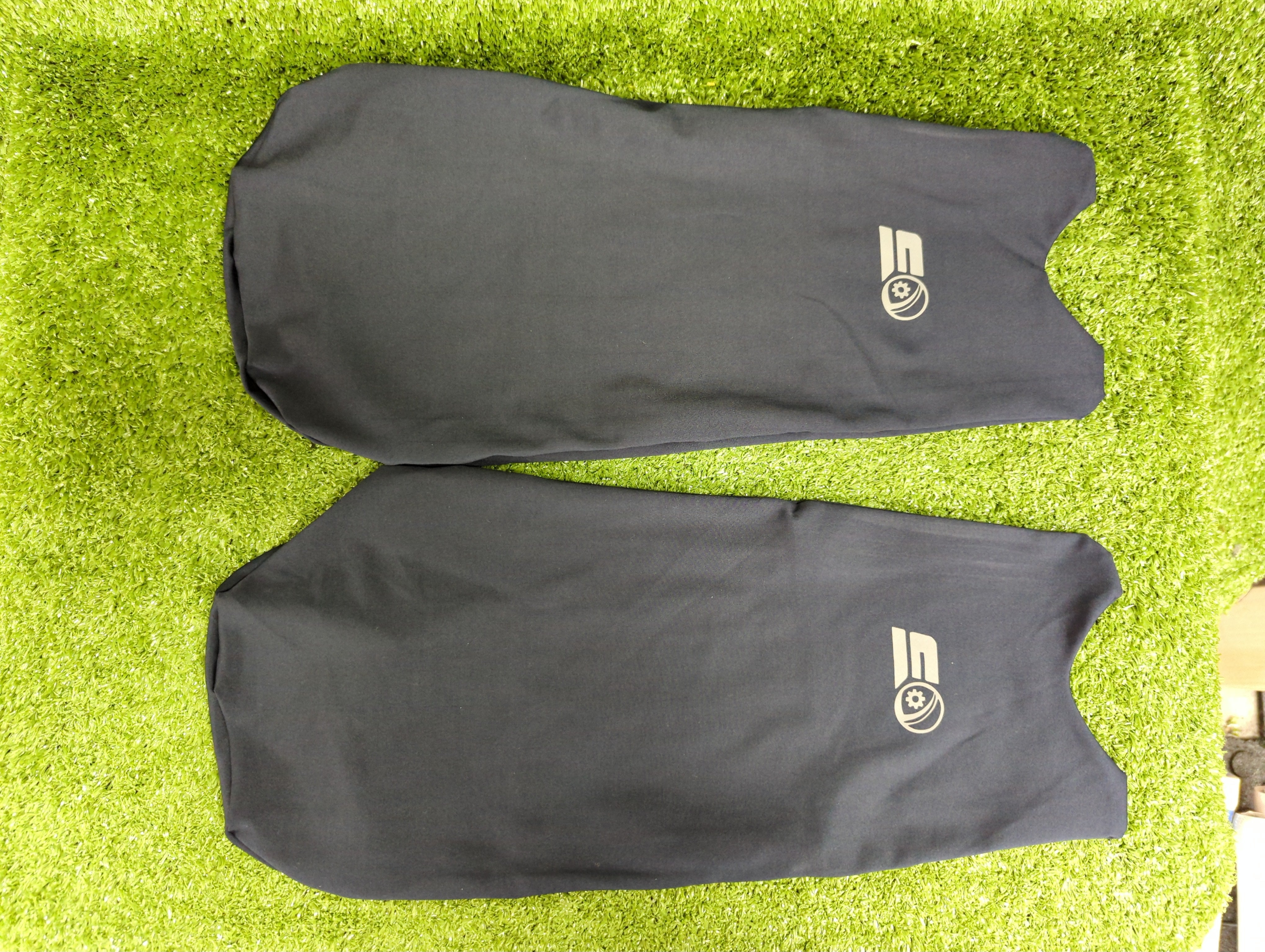 Close-up of the front fabric texture on the navy blue Raydn youth cricket batting pad covers.