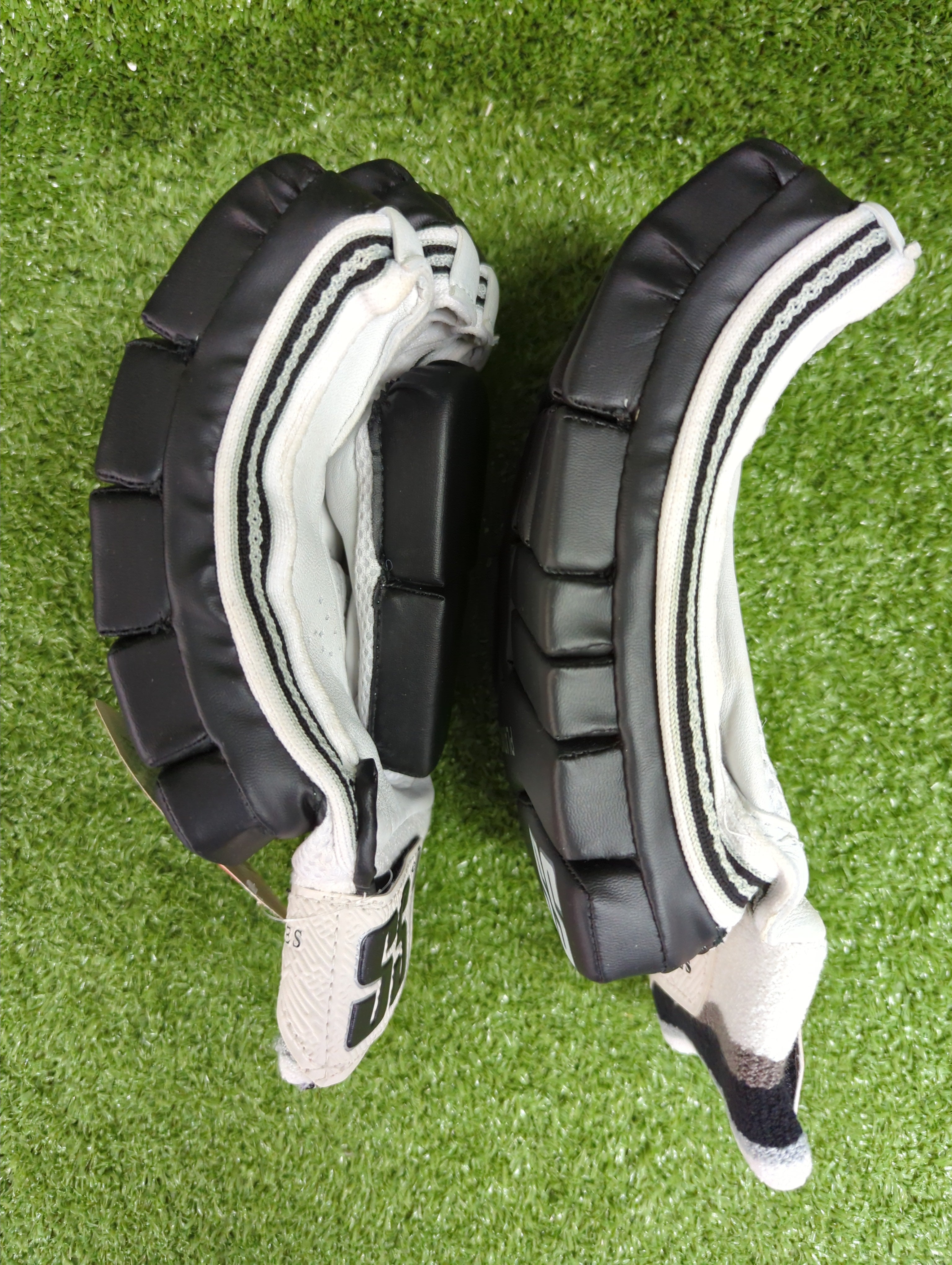 Back of hand view showing SS branding and black styling