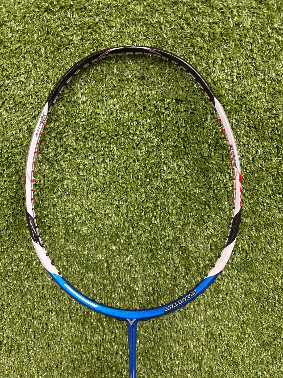 Close-up detail of the Victor Brave Sword 12 Pro (BRS-12) diamond-shaped aerodynamic head frame and unstrung string bed.