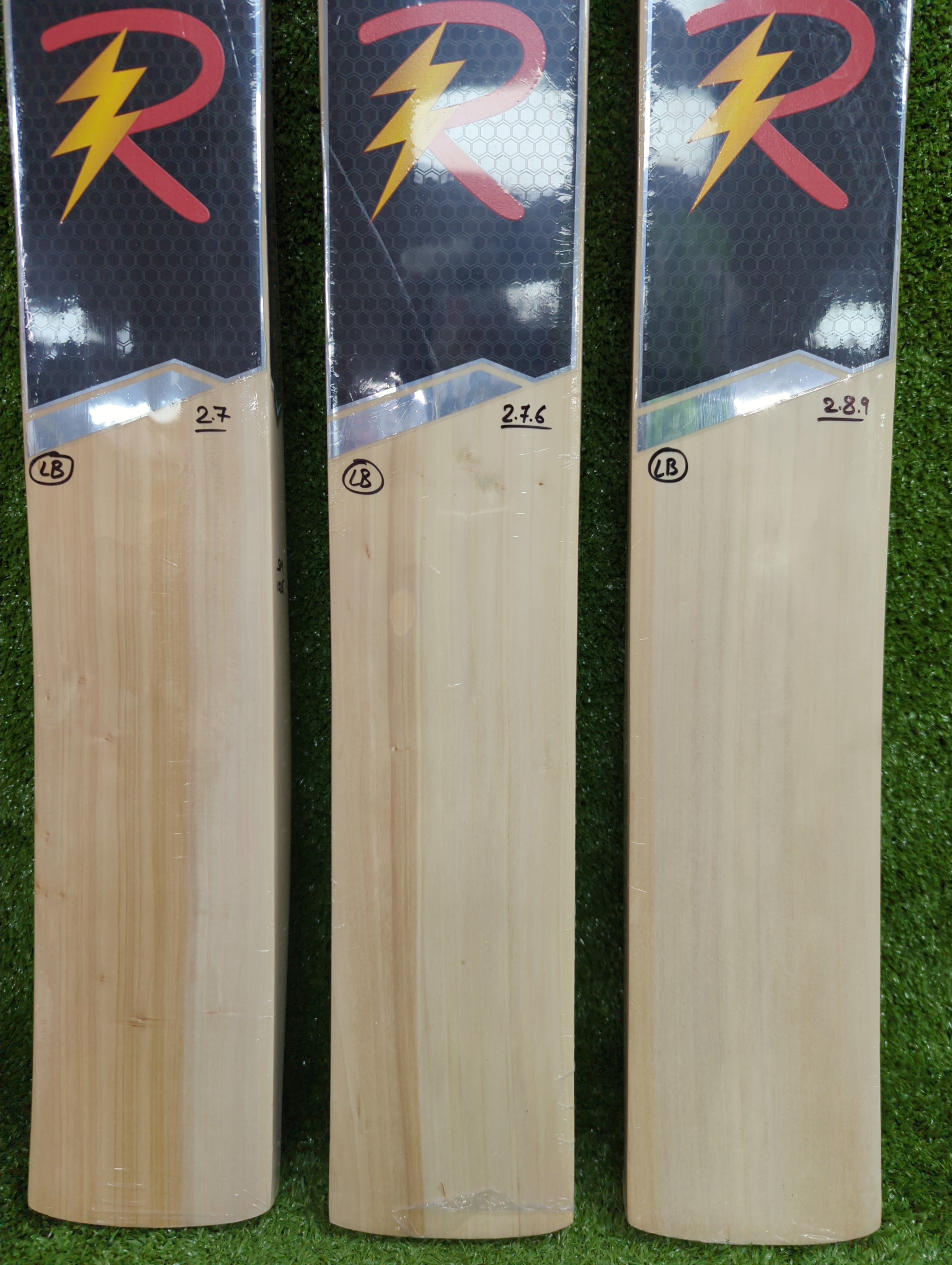 Close-up detail of Raydn VK Profile tennis bat showing thick edges, clean Kashmir Willow wood texture, and the reinforced handle shoulder.